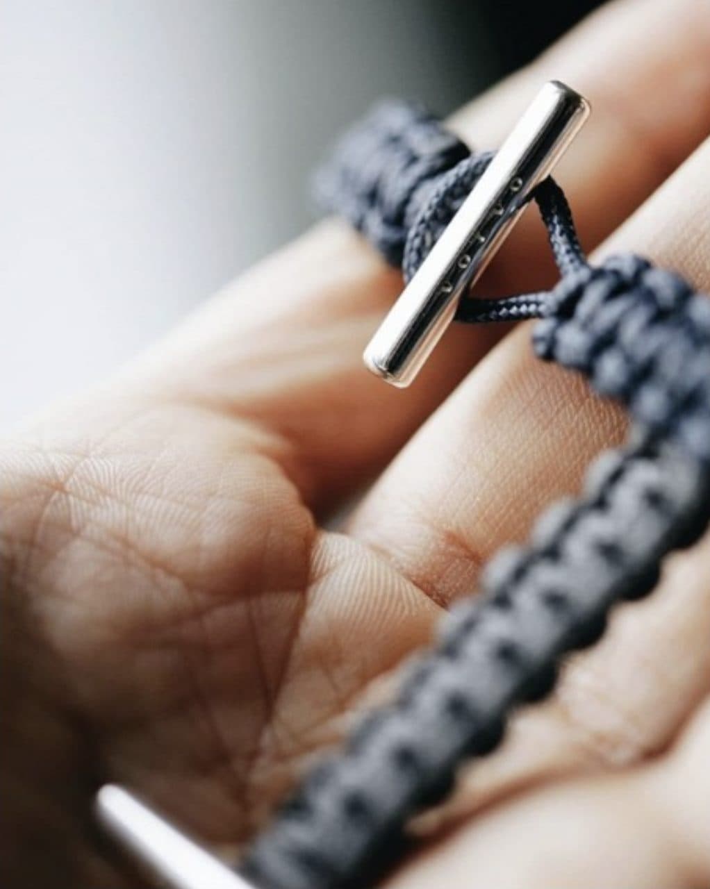 Close-up of rhodium-plated toggle clasp with engraved Volvo wordmark